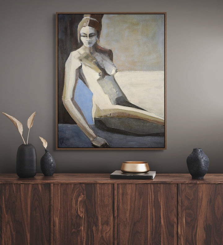 Framed painting of a nude figure on a wall above a wooden cabinet with decorative items.
