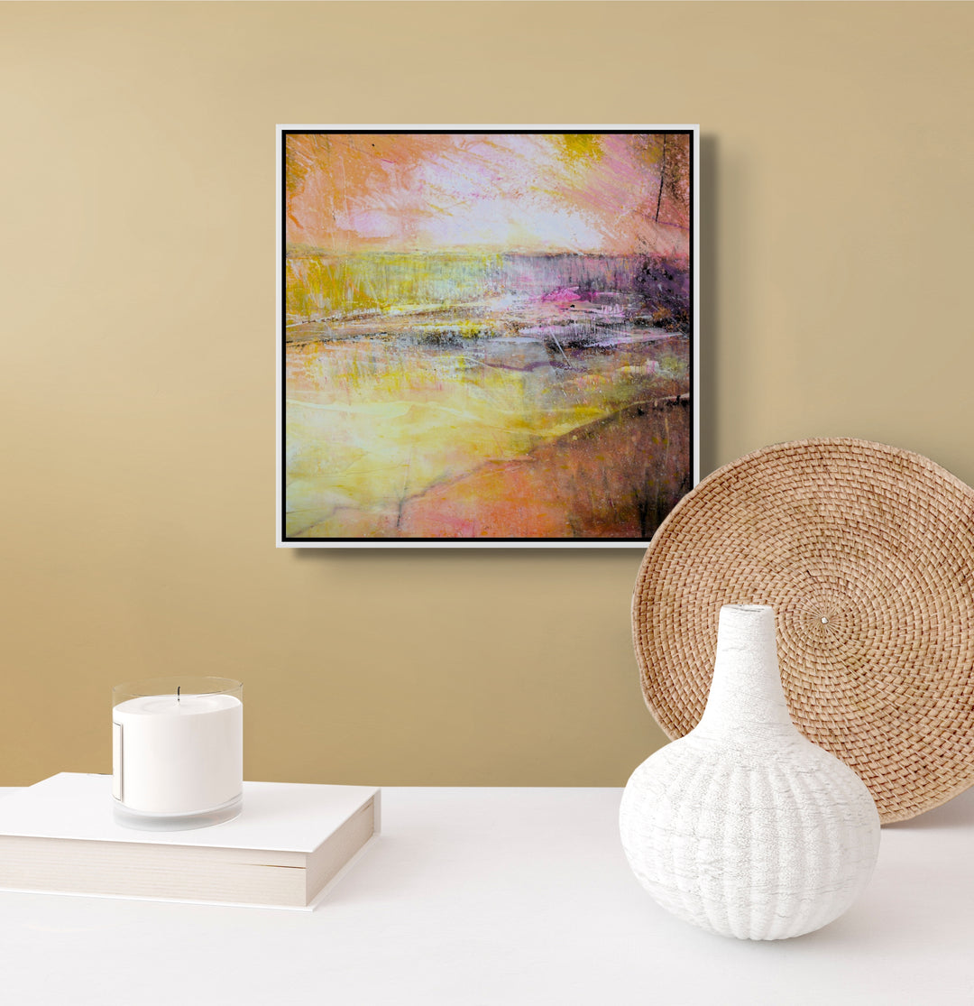 Abstract painting on a beige wall with pink, orange, yellow and white.