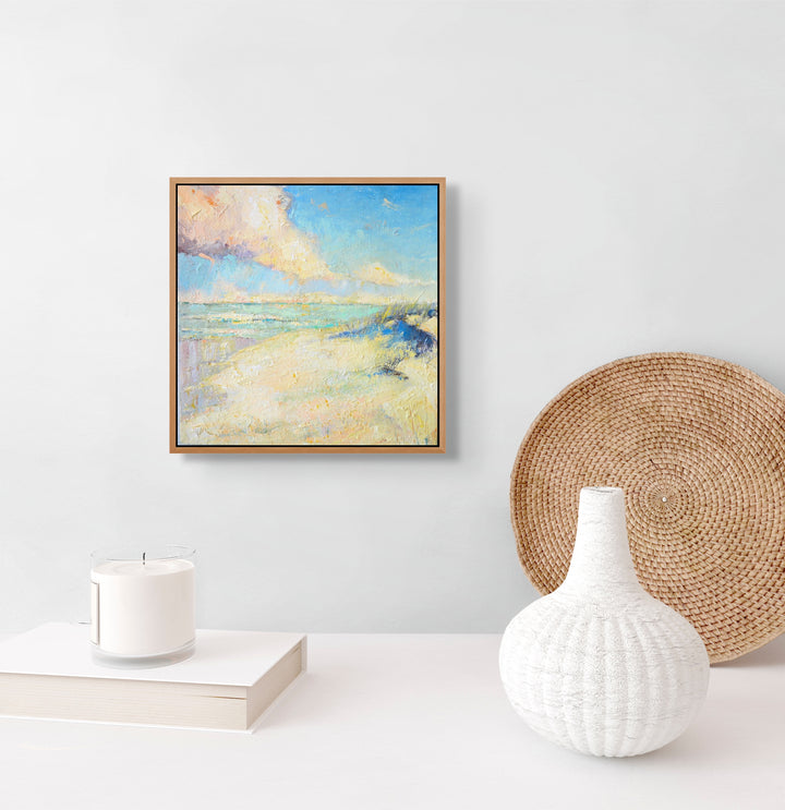 Framed beachy artwork on a white wall.