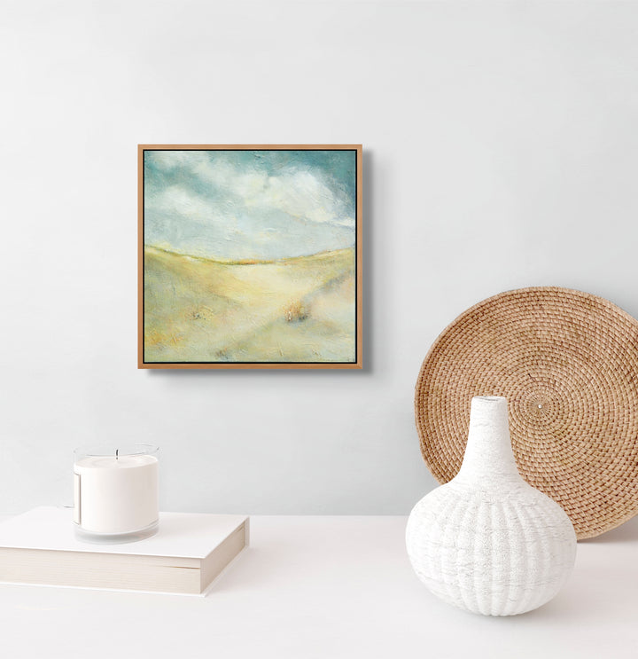 Framed sand dunes artwork on a wall.