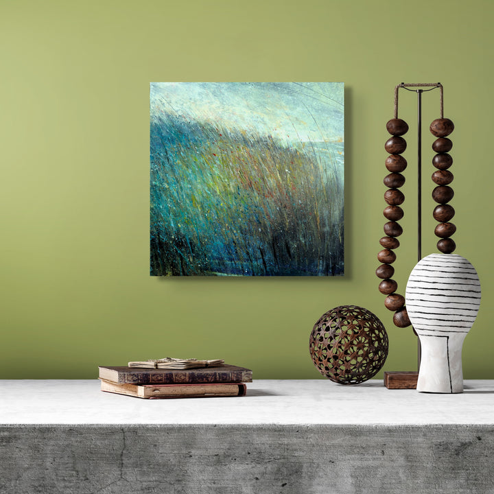 Square small abstract painting on a green wall.